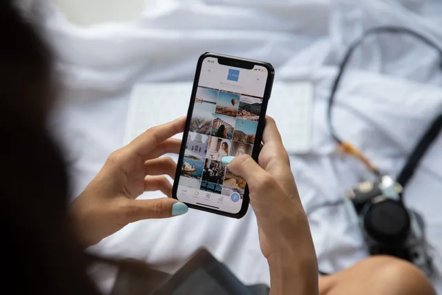 A person interacts with a smartphone displaying social media content in Bali, Indonesia. Bill 96 French social ads Quebec: rules and penalties