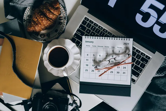 A serene workspace setup with coffee, croissant, laptop, and calendar, ideal for organizing plans. What teams ask about social media content planning