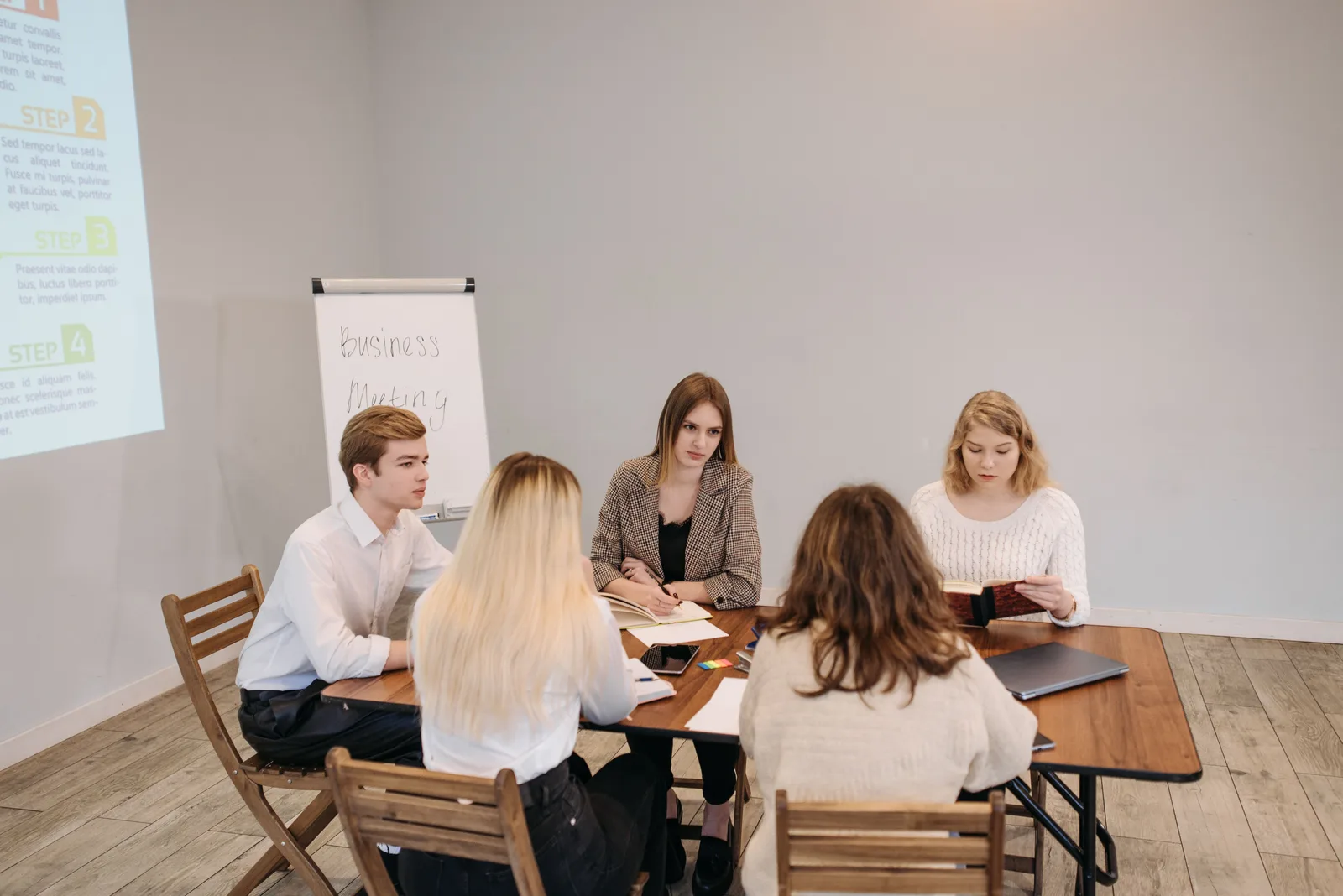 Diverse team engaged in a strategic business meeting at an office setting. Collaborative and focused discussion. Social media management: what to keep and what to drop
