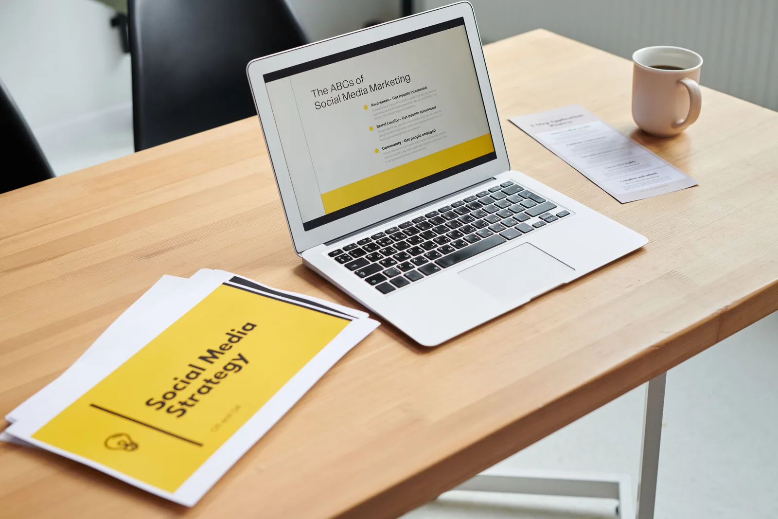 Close-up of a laptop showing a social media marketing strategy in an office setting. Social media management checklist for access, handover and exit