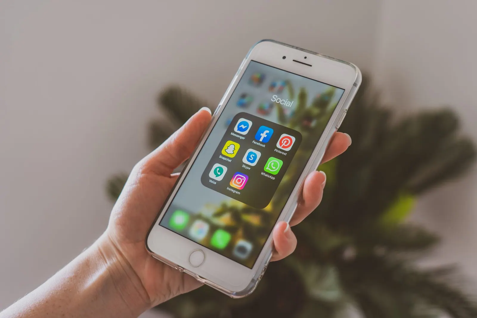 Close-up of a hand holding a smartphone displaying popular social media apps. Eight strategy patterns worth adapting, from customer proof to event extension